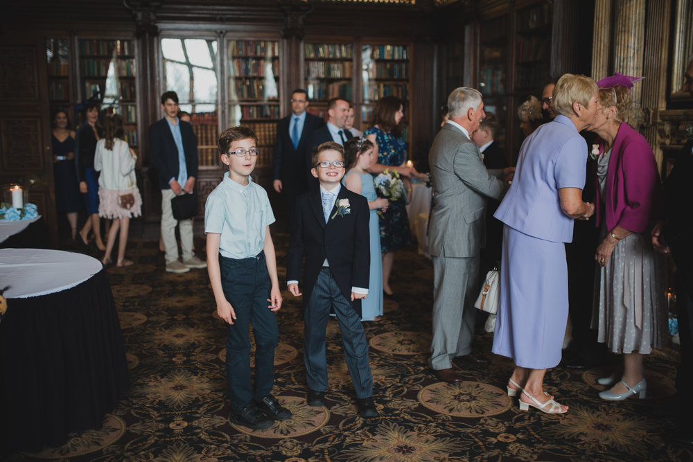  The receiving line in the library at a Crewe Hall wedding in Cheshire. By Amanda Balmain Photography. 