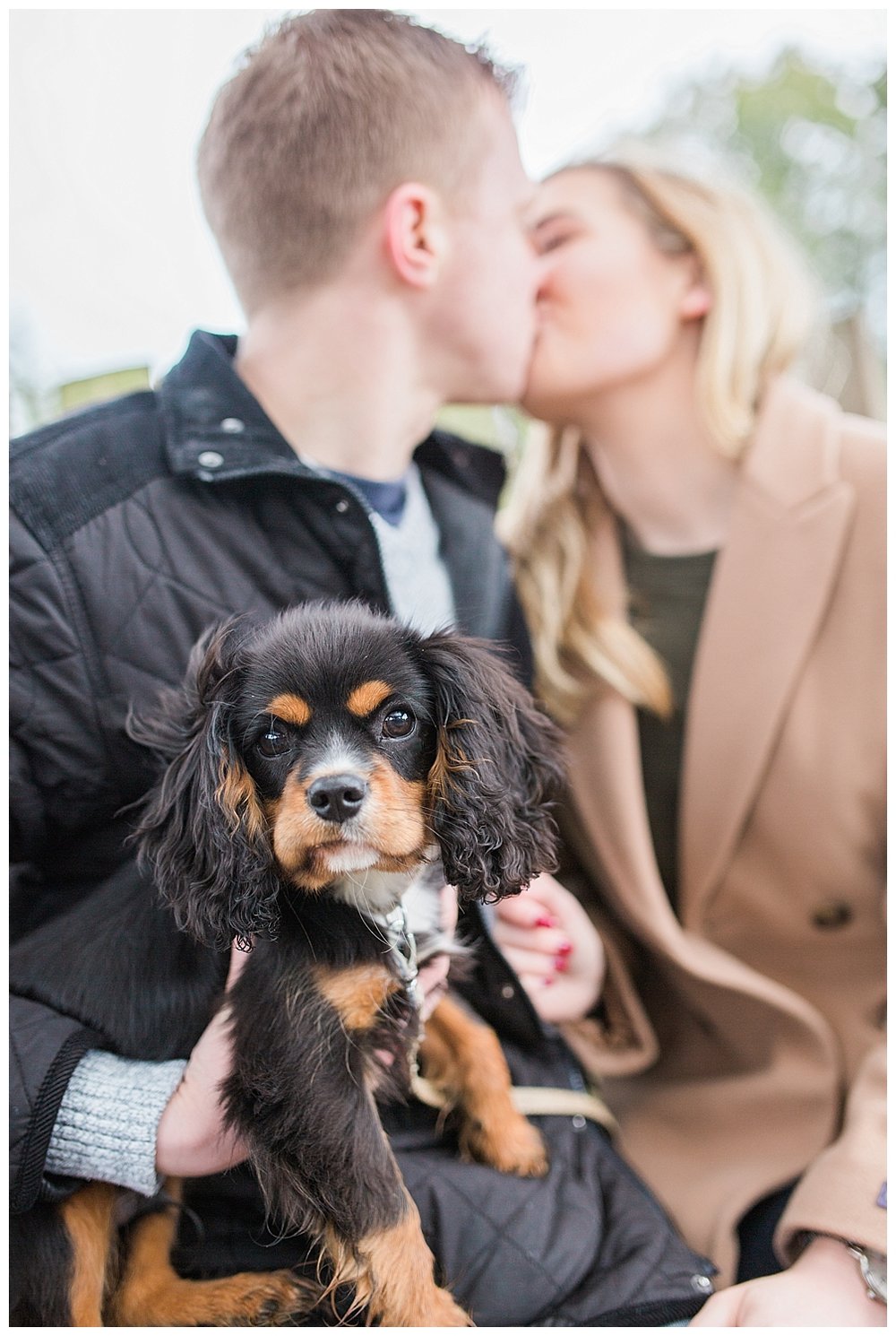  Kissing couple with their King Charles spaniel. 