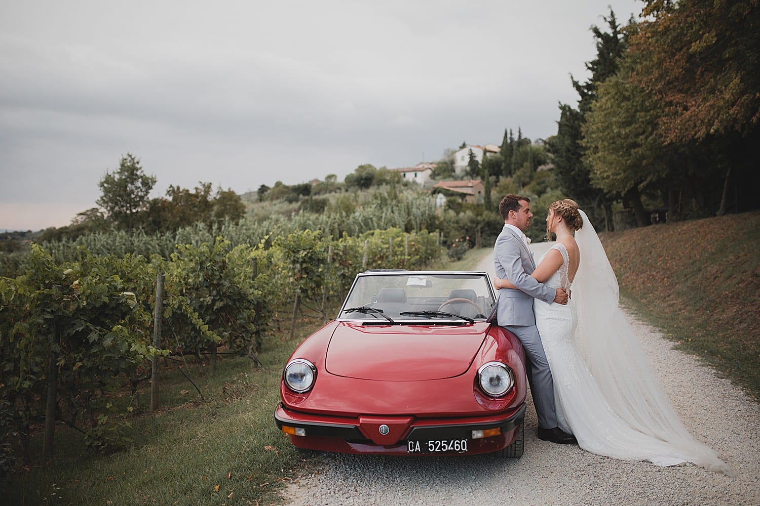 Bride and groom with Alfa Romeo spider