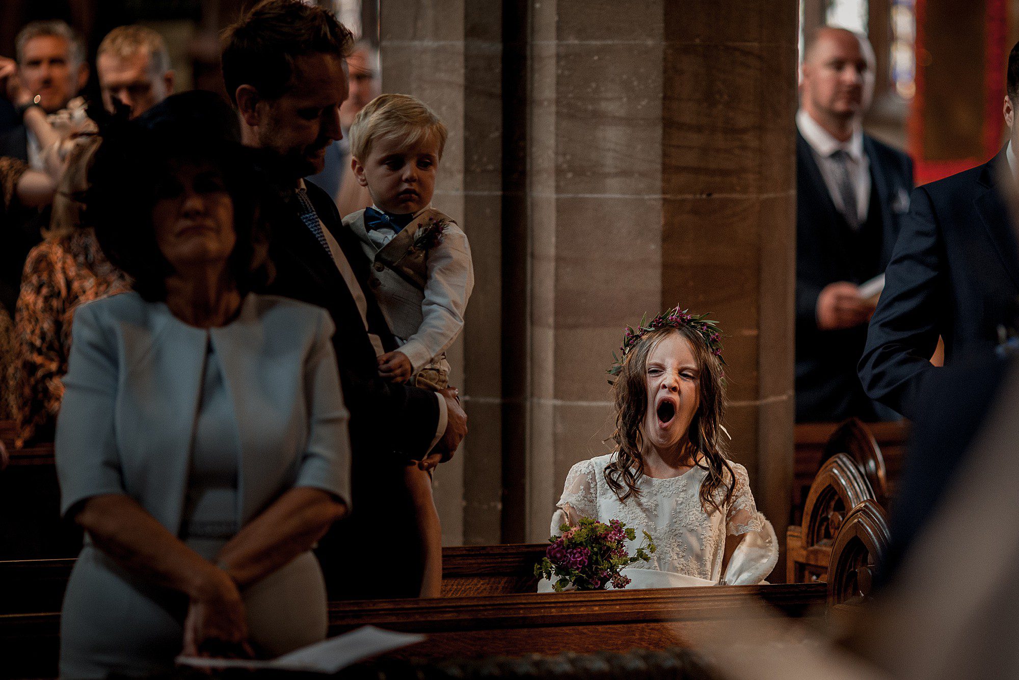 yawning bridesmaid during wedding ceremony