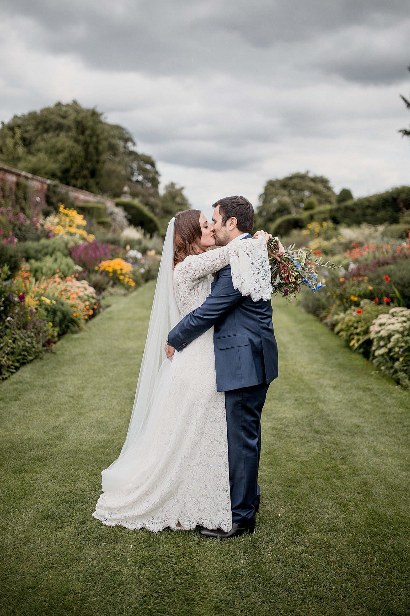wedding couple and herbaceous borders at arley hall