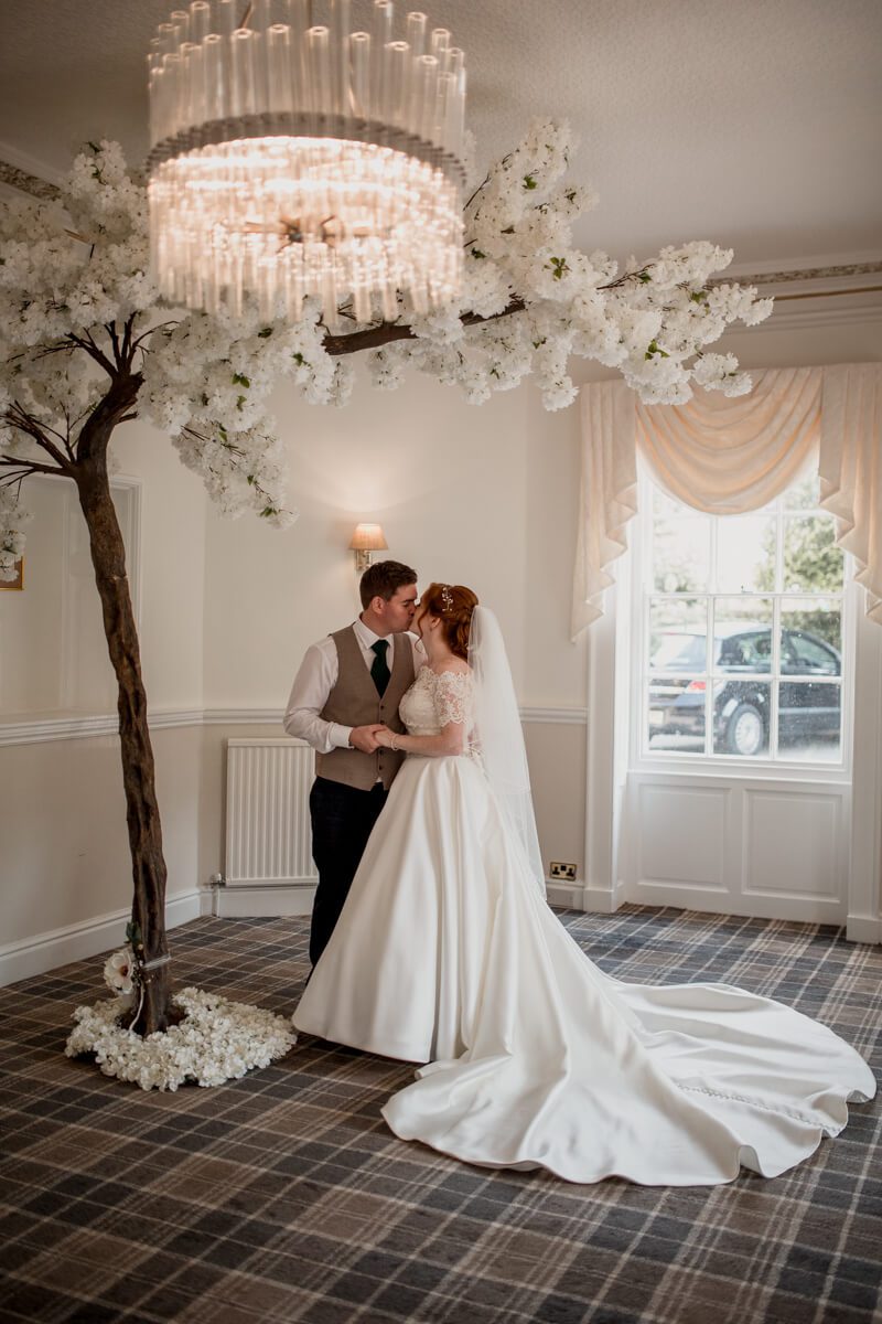 bride and groom with cherry tree decoration 