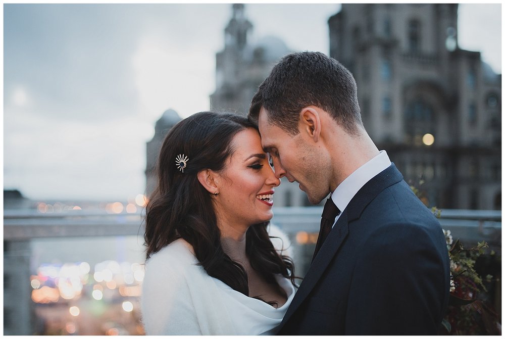  Bride and Groom on the roof terrace at Oh Me Oh My Liverpool overlooking the Liver building. 